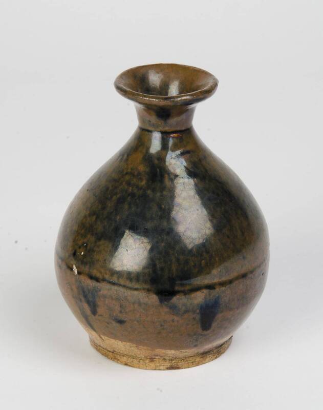 A globular jar with a good black to russet glaze, 15-16th Century. 8cm high