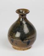 A globular jar with a good black to russet glaze, 15-16th Century. 8cm high