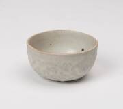 Two small Qingbai vessels, Yuan dynasty (1280-1367), a small bowl with finely molded flower scroll on the outside, 6.9cm diameter; and small molded box and cover, 2.8cm high, 4.9cm diameter.  - 2