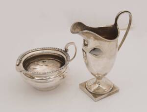 Two George V sterling silver cream jug, a helmet jug by George Nathan & Ridley Hayes, Chester circa 1920, 14cm high: and one by Goldsmiths & Silversmiths Co. 7cm high, 260 grams total weight