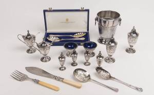 A collection of silver plate, comprising a Georgian style pierced cruet set with a pair of mustard pots, a pair of open salts, a pair of sugar casters, four salt casters; 4 berry spoons, fish servers, a lion mask handled vase and a sterling silver mustard