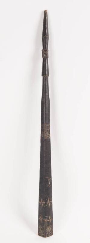 A Solomon Island sword shaped club, with incised decoration and remains of lime finish. 85cm