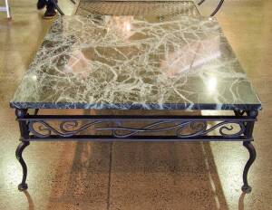 A Mark Douglas Design wrought iron coffee table with marble top, circa 1996. 46cm high, 120cm wide, 106cm deep. 