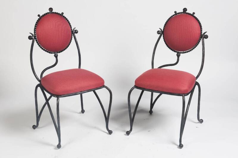 A pair of wrought iron and upholstered occasional chairs. 