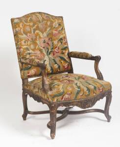 A Louis XV style carved walnut & tapestry upholstered arm chair.