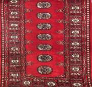 Two Persian patterned runners one hand knotted, one machine made. 82 x 300cm. 