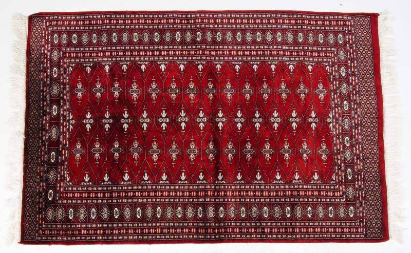 Three hand woven Pakistani red pattern rugs. Approximately 130 x 155cm each. 