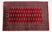 Three hand woven Pakistani red pattern rugs. Approximately 130 x 155cm each. 