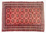 Three hand woven Pakistani red pattern rugs. Approximately 130 x 155cm each.  - 2