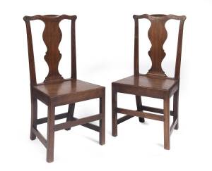 A pair of George III English oak side chairs.