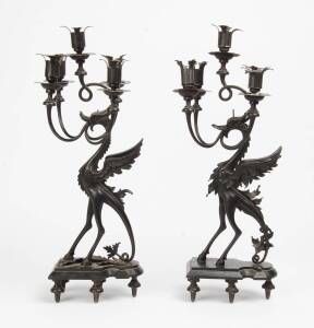 A pair of wrought iron 5 branch mythical creature figured candelabra. 60cm.