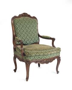 A Louis XV style walnut carved fauteuil.  