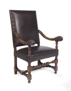 A Louis XIV style carved walnut & leather upholstered armchair. 