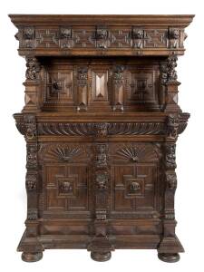 An ornately carved oak court cabinet with lions masks and faces. Early 19th Century. 220cm high, 157cm wide, 70cm deep.