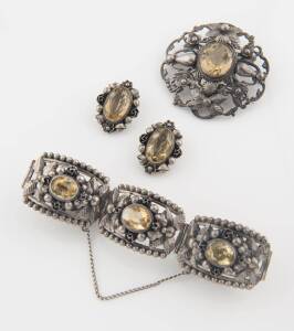 A citrine suite, Peruzzi, Italy, of foliate and floral design and comprising a bracelet, brooch and earrings. Sterling silver. Earrings with clip attachments. 