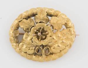 A gold brooch, in the style of Lamborne and Wagner, of floral and foliate design. 18ct yellow gold. Weight: 5.8 grams. 