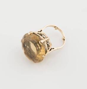 A citrine cocktail ring, the central citrine measuring 23mm. Size O 1/2. 9ct yellow gold. Weight 15.9 grams. 