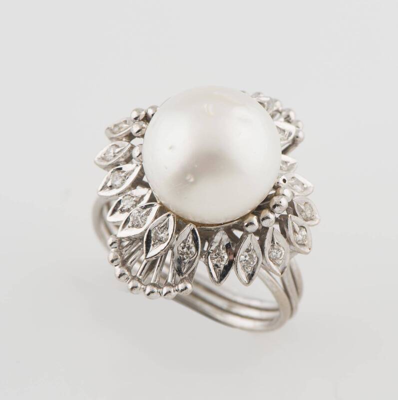 A diamond and pearl dress ring, of cluster design with a central pearl. 14ct white gold. Size N. Weight 9.1 grams. 