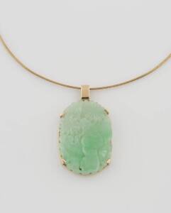 A jadeite pendant, the pendant of carved floral design. 14ct yellow gold and silver. 38mm x 27mm. 