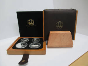 CANADA: 1973-1976 Montreal Olympics Proof Coin Collection, seven sets of four coins ($5 x2 & $10 x2) in separate presentation cases plus walnut display rack, all in original packaging as delivered. (28 coins)