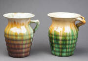 REMUED: Two branch handled pottery vases glazed in green, yellow mauve & brown. Incised signatures & 196/7 shape number. 18cm each. 