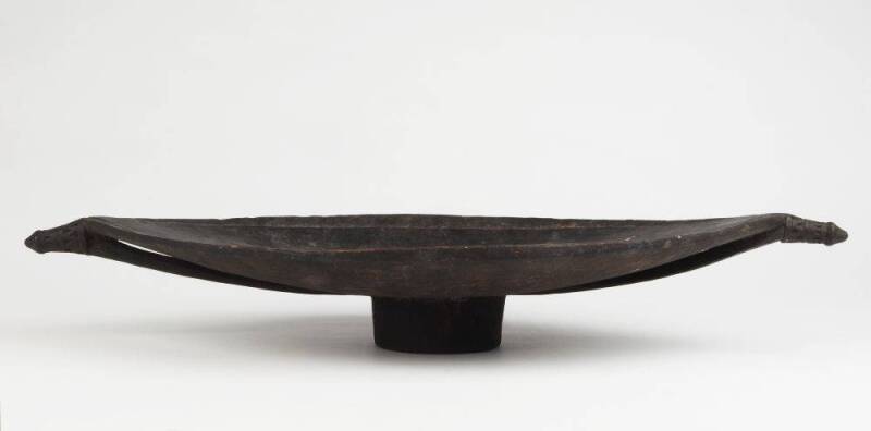 A FEASTING BOWL. Schouten Islands, Papua New Guinea. Carved wood & pigment. 56 x 28 x 8.2cm