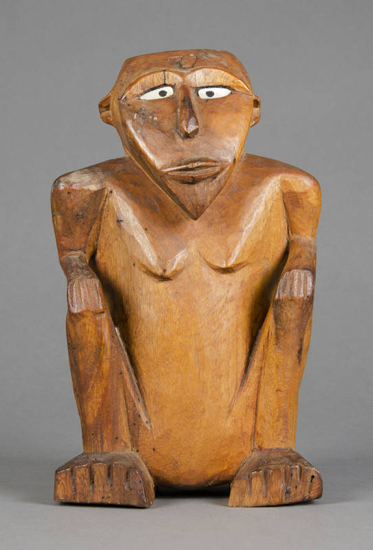 A RARE squatting figure; Caroline Islands, Micronesia. Carved wood, shell & resin. 30.5cm