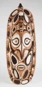 A Highly Decorated Tami Mask. HUON GULF, Papua New Guinea. Carved wood, shell & natural earth pigments. 72cm