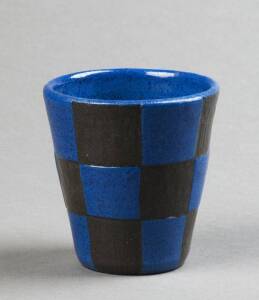 OSREY: Beaker glazed in blue & black checker board design. Incised "Osrey Ballarat 1924". Height 8cm