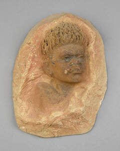 WILLIAM RICKETTS: Pottery face plaque of an Aboriginal boy. Incised signature, minor chip.