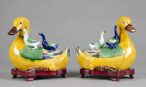 Pair of Chinese polychrome ducks glazed in yellow, blue & green. Each one with two little ducks on its back. Both resting on carved wooden stands. 25 x 22cm each. Excellent condition