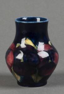 MOORCROFT: Pansy patterned balluster shaped vase on blue ground. 9.5cm. VG condition