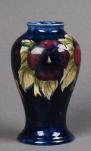 MOORCROFT: Pansy patterned vase on dark blue groud c1930s. Beautifully executed floral decoration. Underglazed signature in blue. 16cm. VG condition