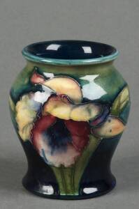 MOORCROFT: Orchid patterned balluster shaped vase on green/blue ground. 8cm. VG condition
