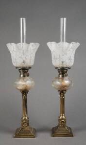 Pair of antique oil lamps; single burners with cut crystal fonts on brass Corinthian column bases. Acid etched shades and glass chimneys. 54cm each