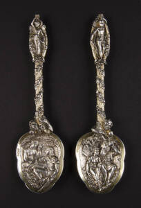 STERLING SILVER: Fine pair  serving spoons with Shakespeare themes; "Titania & Bottom", plus "Miranda & Ferdinand". Each one adorned with fairy top. Gilt wash finish, London hallmarks. Weight ,height 21cm