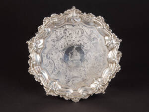 STERLING SILVER SALVER. Georgian with heavy leaf patterned srolling border & engraved floral motif all resting on three baroque style feet. Emblazoned with family crest & motto "Fidus et Audax" (faithful & bold). Made in London c1831. Weight 385 grams, 20