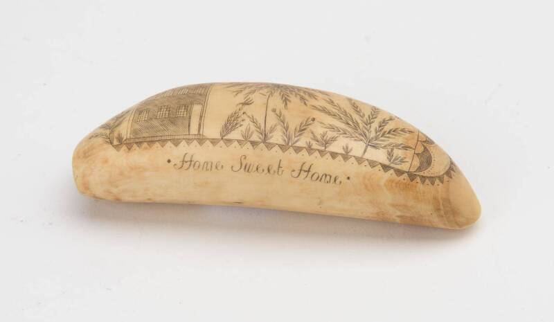 A scrimshaw whale's tooth titled "Home Sweet Home". 12cm.