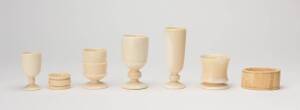 Group of whale's teeth and bone turned egg cups and napkin rings, 19th Century. Largest 10cm