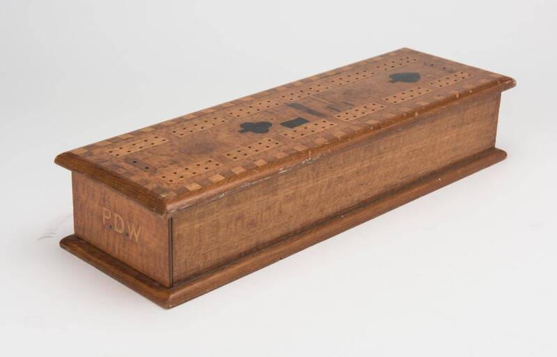 An Australian timber games box, silky oak, cedar, pine and blackwood, monogrammed "P.D.W" on the drawer front, circa 1900. 8cm high, 39cm wide, 12.5cm deep