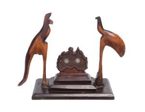 A pine cedar and mulga wood folk art carving, circa 1910, inset with two Australian three pences. 28cm high 