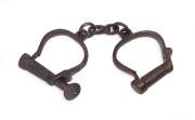 A pair of manacles with key, stamped "British Made", 19th Century.