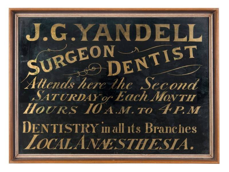 A reverse glass shop sign  "J.G. Yandell Surgeon Dentist, Attends Here the Second Saturday of Each Month, Hours 10a.m. to 4p.m., Dentistry in all its branches, Local Anesthesia". 48 x 35cm