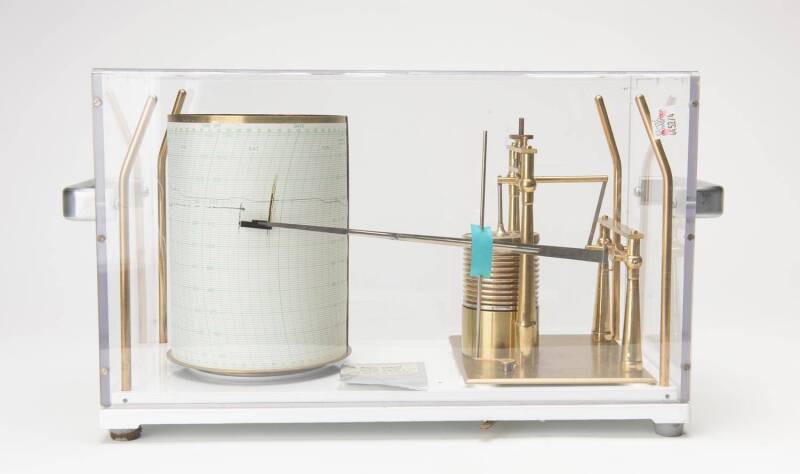 Microbarograph by Short & Mason of London. Measures and records barographic pressure over seven day period, includes charts. Range 950-1050mb. 24cm high, 39cm wide, 18cm deep.