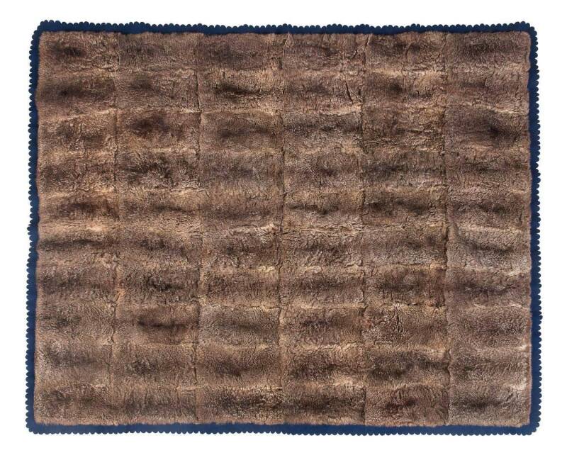 A possum skin rug on blue felt backing bearing label "Manufacturing Furriers, J.Jackson & Sons, Tivoli Fur Store, Albert Square, Brisbane",  early 20th Century. 184cm x 152cm. Provenance: The rug was originally commissioned by the vendors mother during th