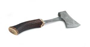 A tomahawk, hand forged steel finely engraved with a kangaroo and emu, horn handle with brass pommel engraved with monogram "G.S", 20th Century. 33cm