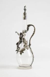 ANTIQUE WINE JUG: Silver plated mount with grapes & leaves adorned by female nude in drappery holding a bunch of fruit. Unusual figured stopper. Plating worn in places. 38cm, Good condition