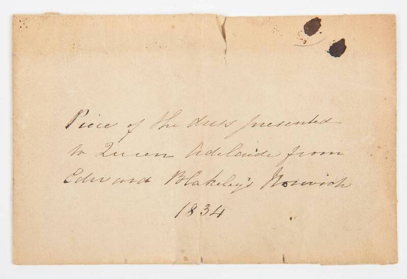 QUEEN ADELAIDE (1792-1849, wife of King William IV, after whom city of Adelaide is named): Envelope marked "Piece of the dress presented to Queen Adelaide from Edward Blakeley's Norwich 1834", containing sample of bright red material.