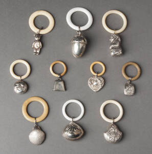 BABY RATTLES: Group of 10 vintage silver rattles on rings. Gnome, bear, bells etc