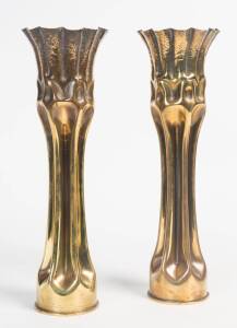 A pair of trench art vases. 38cm high